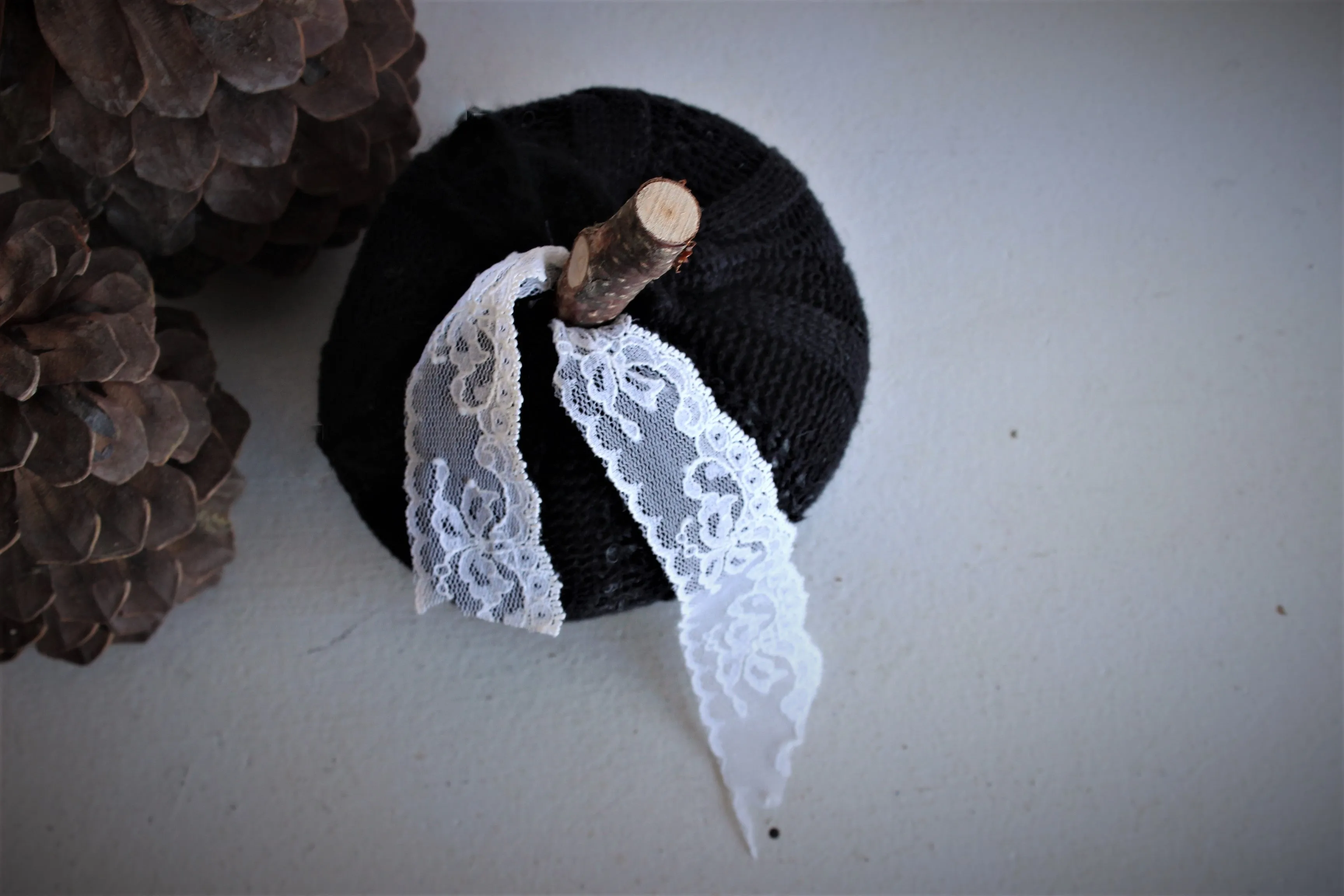 Knit Mini Pumpkin Pillow Pouf in Black with Ivory Lace and Wooden Stem